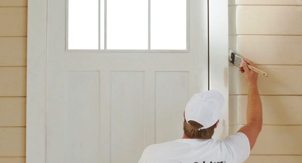 Painter painting a door