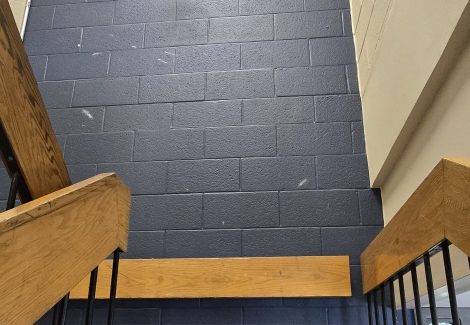 commercial stairwell with dark blue wall
