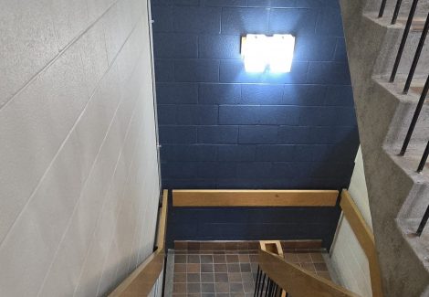 commercial stairwell with white and dark blue wall