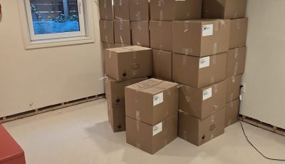 cardboard boxes stacked in corner of room