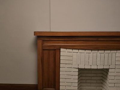 brick fireplace with wood mantle