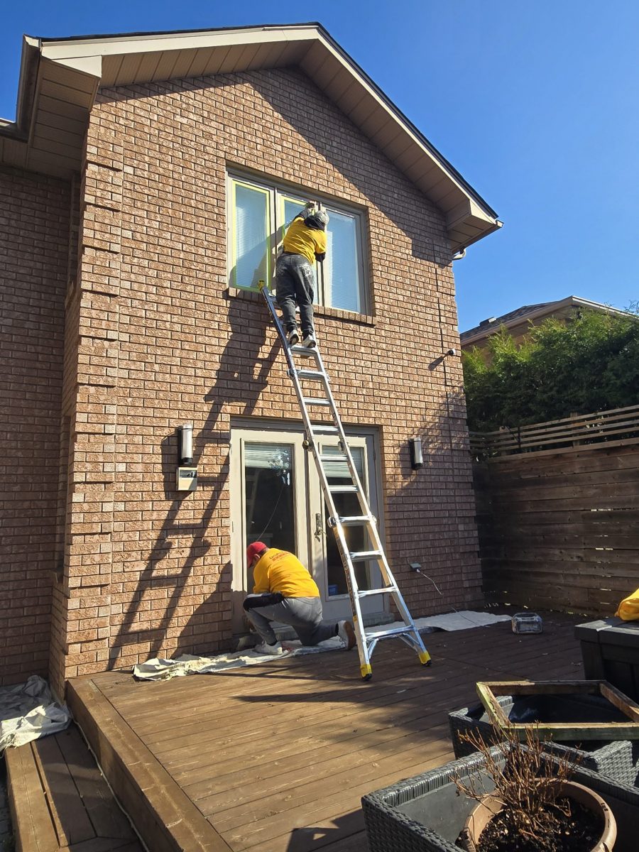 painting team on ladders against brick house exterior Preview Image 2