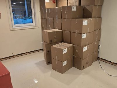 cardboard boxes stacked in corner of room