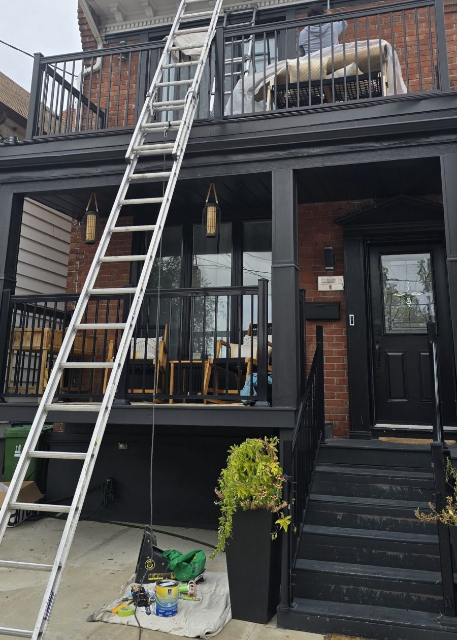ladder leaning against house exterior with black painted porch and upper deck Preview Image 11
