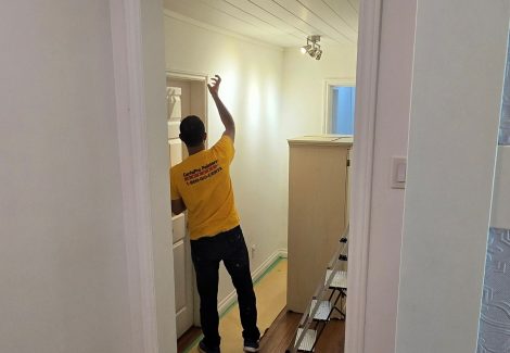 painter working on home interior walls