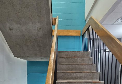 teal and white painted walls in commercial stairwell