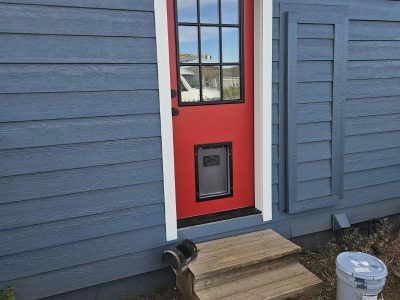 house with blue painted siding and red door