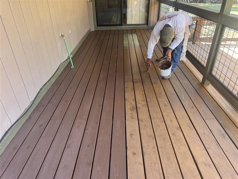 painter staining a wooden deck Preview Image 2