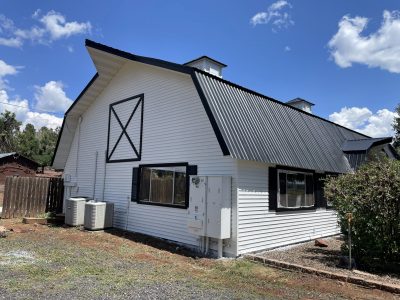 white painted barn with black roof