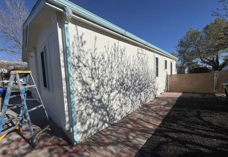 white house exterior with blue trim and roof