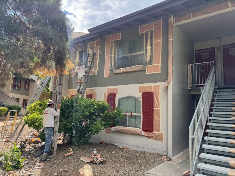 painters with prepped stucco building exterior during repaint Preview Image 8