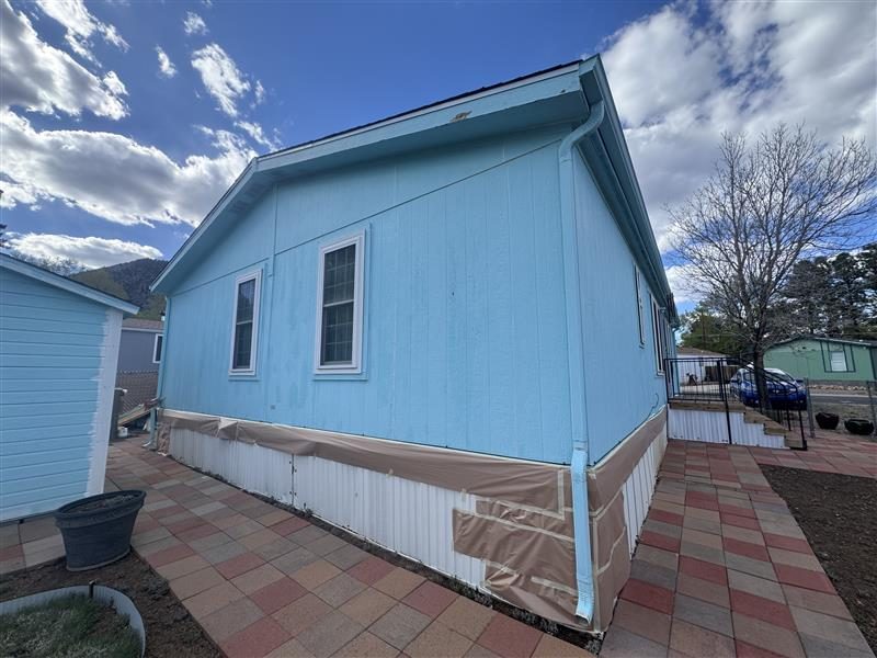 house exterior with blue siding and white repaint Preview Image 4