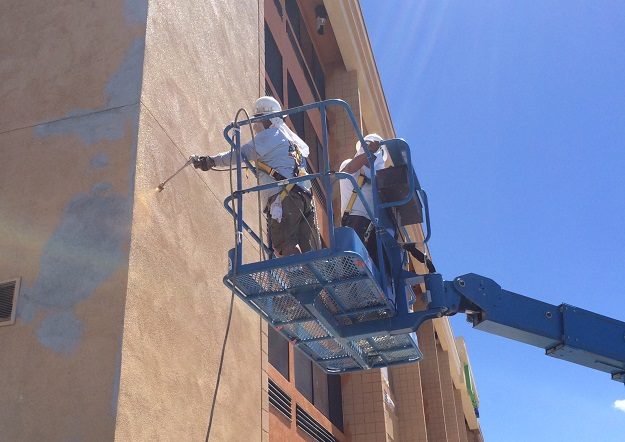 painters on boom lift spraying building exterior Preview Image 2