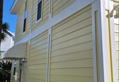 house with yellow painted siding and white trim