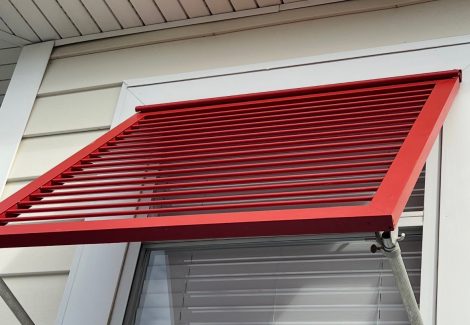 red painted metal window awning