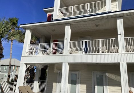 white house exterior with multi-level balconies