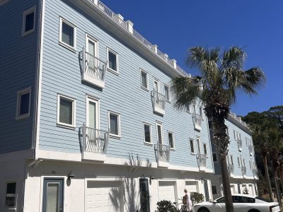 condo building exterior with painted blue siding and white trim and accents