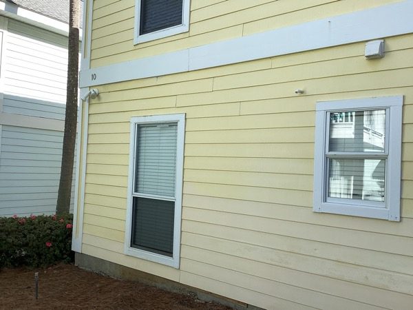 house with worn yellow siding and white trim Preview Image 5