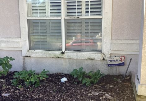 house exterior with faded stucco siding and damaged trim