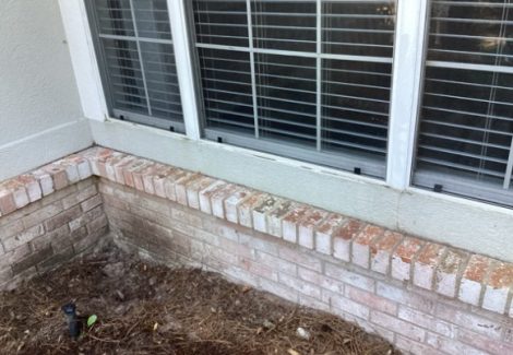 worn stucco and brick exterior