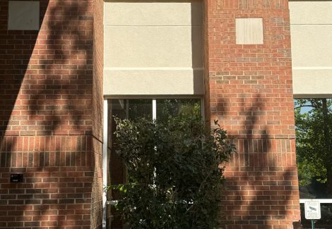 exterior of stucco and brick commercial building