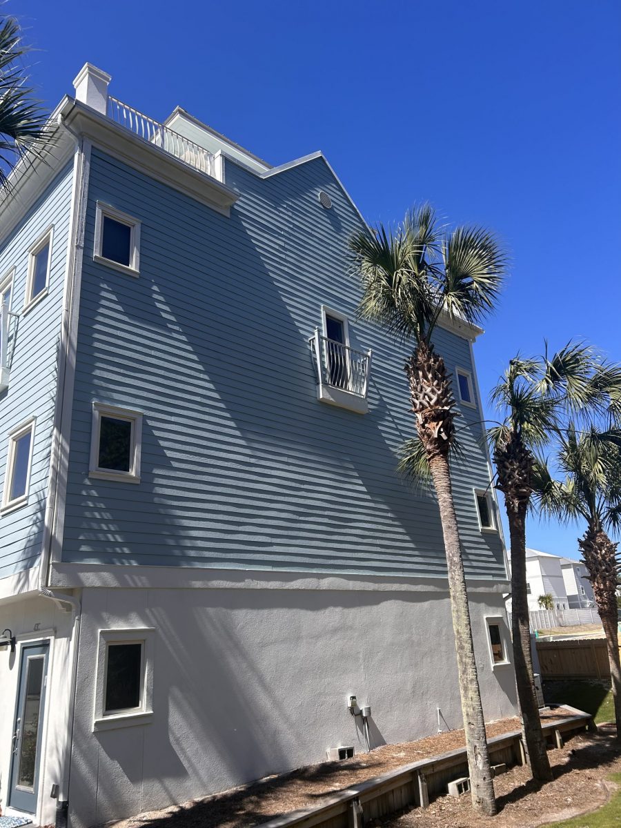 condo building exterior with painted blue siding and white trim and accents Preview Image 3