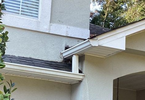 areas of worn stucco on house exterior