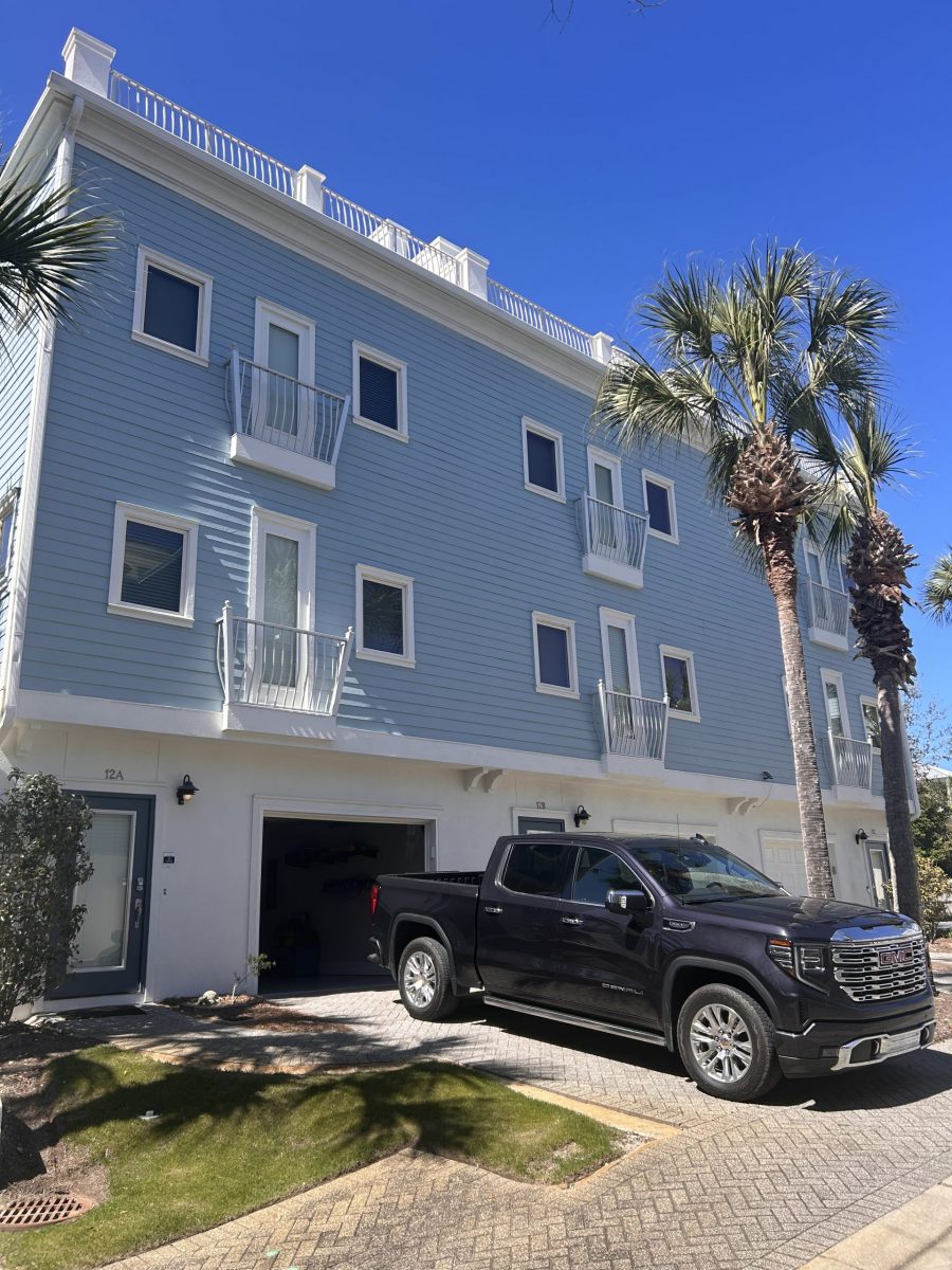 condo building exterior with painted blue siding and white trim and accents Preview Image 7