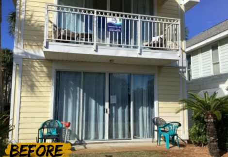 house with worn yellow siding and white balcony