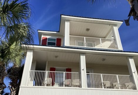 white house exterior with red shutters