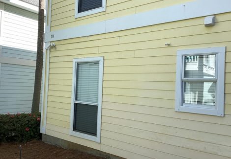 house with worn yellow siding and white trim