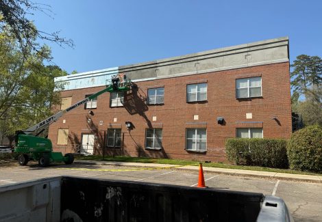 boom lift and exterior of commercial building during stucco install