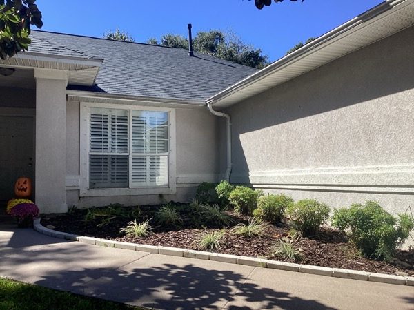 house exterior with faded stucco siding and damaged trim Preview Image 5