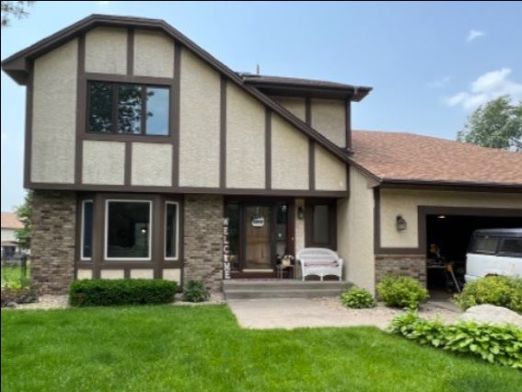 front of house with tan stucco and brown trim