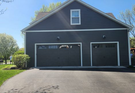garage side of house with gray siding and driveway