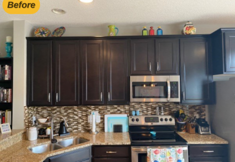 kitchen counter with appliances and black cabinets