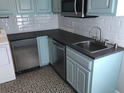 blue painted kitchen cabinets with appliances