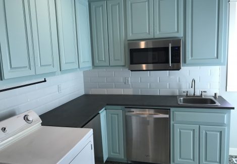 blue painted kitchen cabinets with appliances