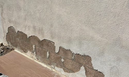 An area where the stucco fell away from the brick.