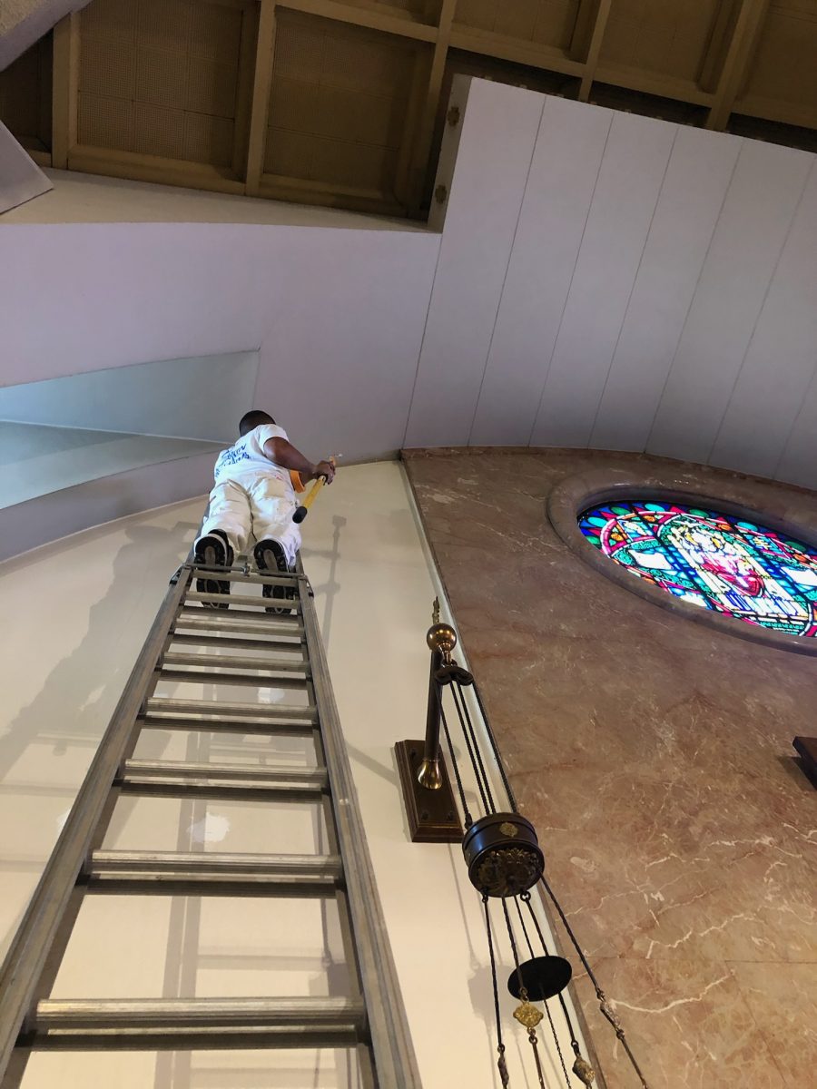 painter on ladder against church altar wall Preview Image 1