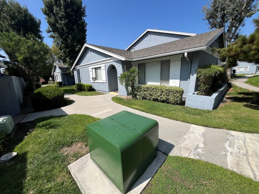 sidewalk view of repainted apartment building Preview Image 1
