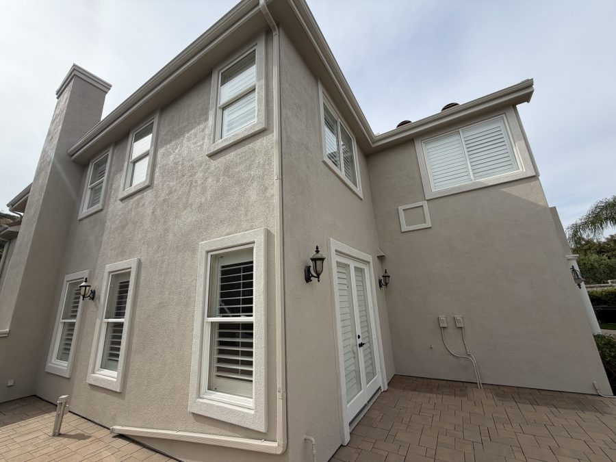 painted stucco and stone house exterior with upper balcony Preview Image 6