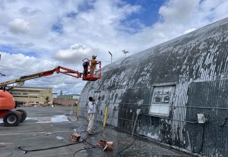 painter on boom lift working on building exterior