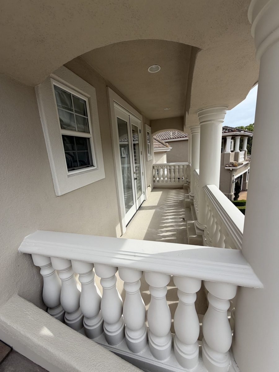 house balcony with painted stucco and railing Preview Image 5
