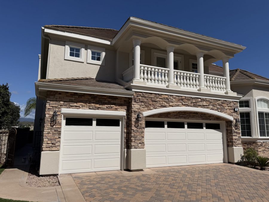 painted stucco and stone house exterior with upper balcony Preview Image 8