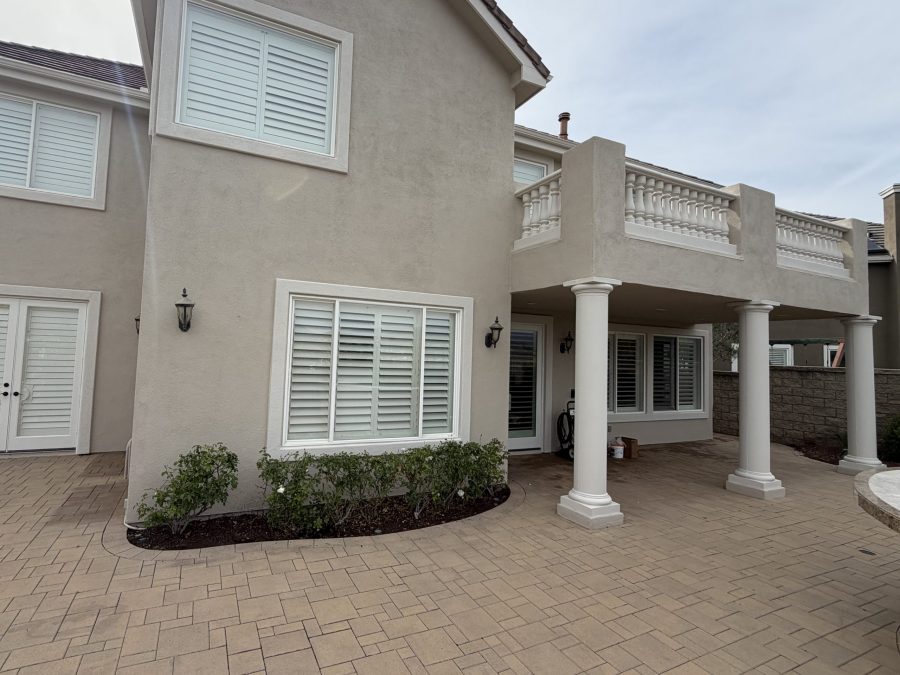 painted stucco and stone house exterior with upper balcony Preview Image 1