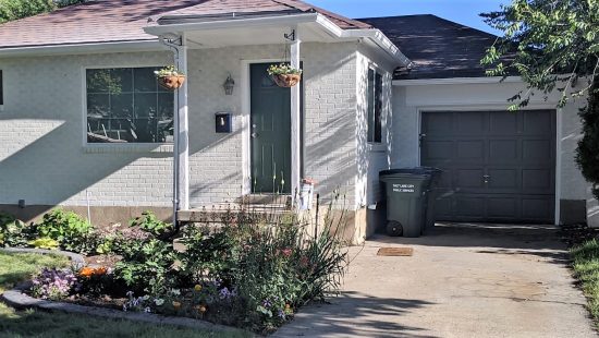 Brick home repainted white