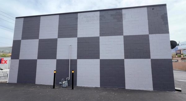 concrete commercial building with dark and light grey checkered paint design