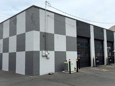 concrete commercial building with dark and light grey checkered paint design