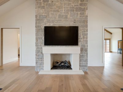 gray stone fireplace mantel with television